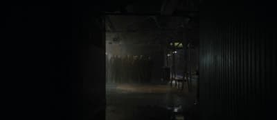 a group of people standing in a dark room