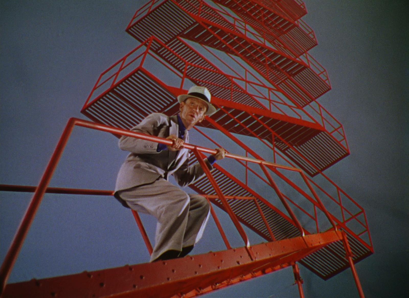 a man standing on a red metal structure