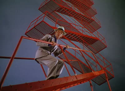 a man standing on a red metal structure