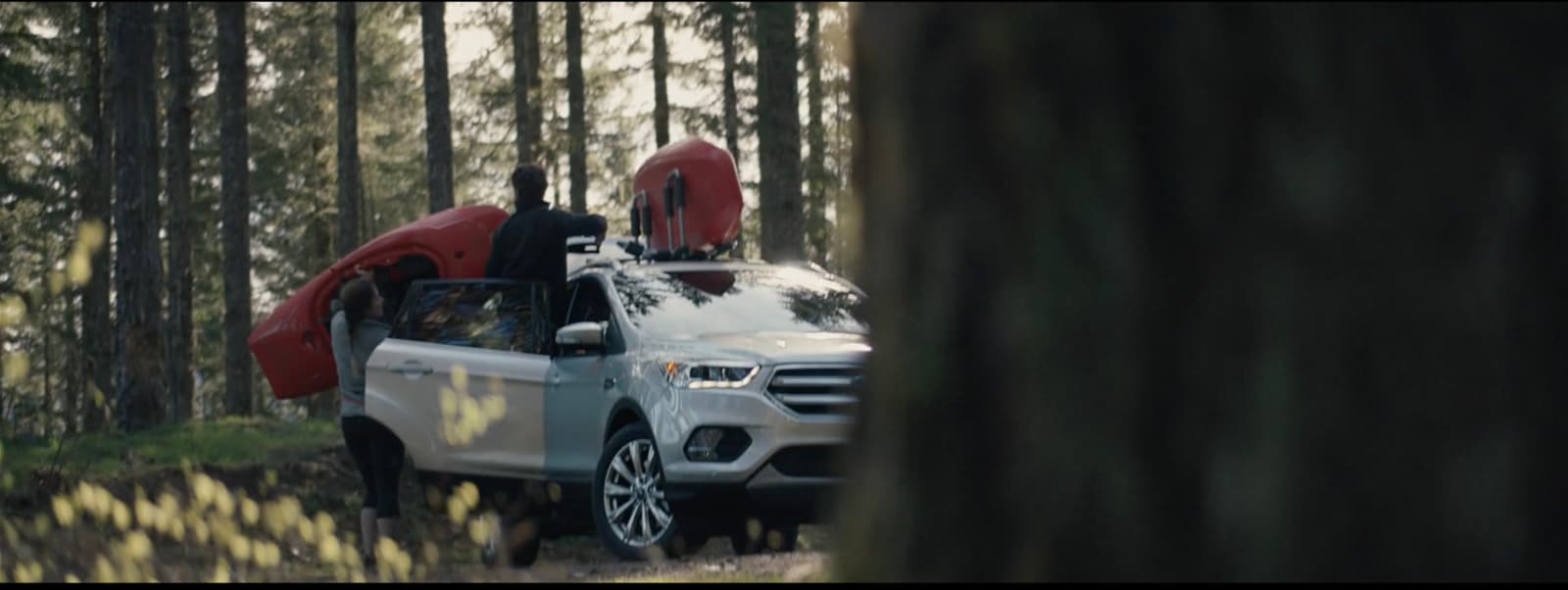 a white truck with a kayak on the back of it
