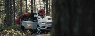 a white truck with a kayak on the back of it