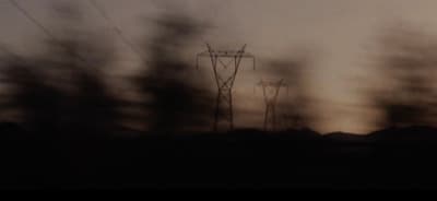 a dark picture of power lines in the distance