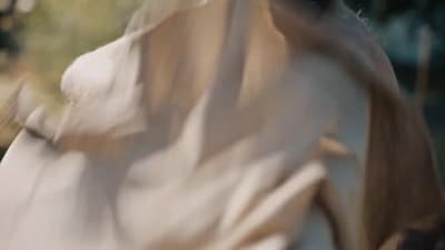 a blurry photo of a woman in a white dress