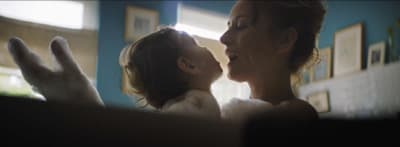 a woman holding a baby in her arms