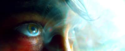 a close up of a person's face with blue eyes