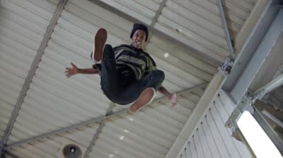 a man flying through the air while riding a skateboard