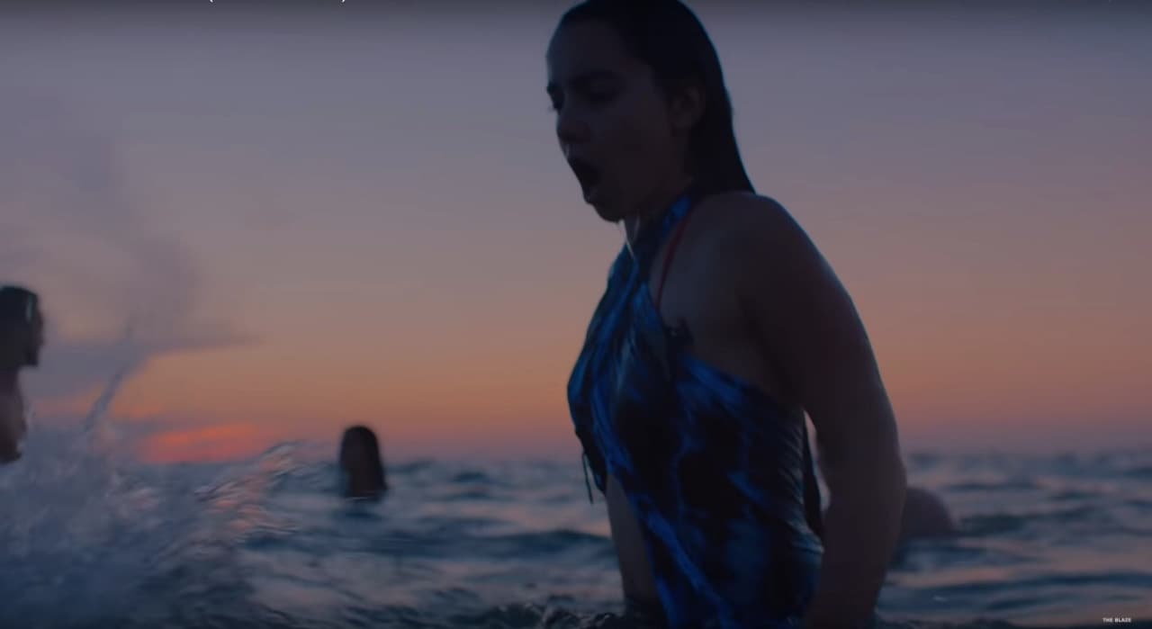 a woman in a bathing suit standing in the water