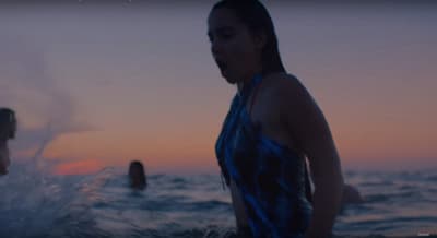 a woman in a bathing suit standing in the water