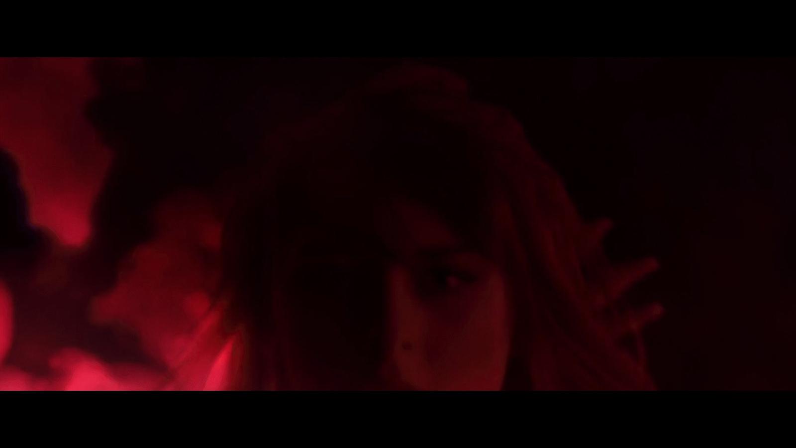 a woman standing in front of a red light