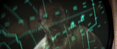 a man standing in front of a tv screen