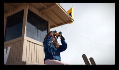 a woman looking through a pair of binoculars