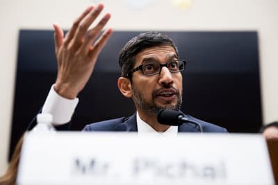 a man in a suit and tie giving a speech