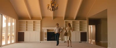 a man and a woman standing in a living room