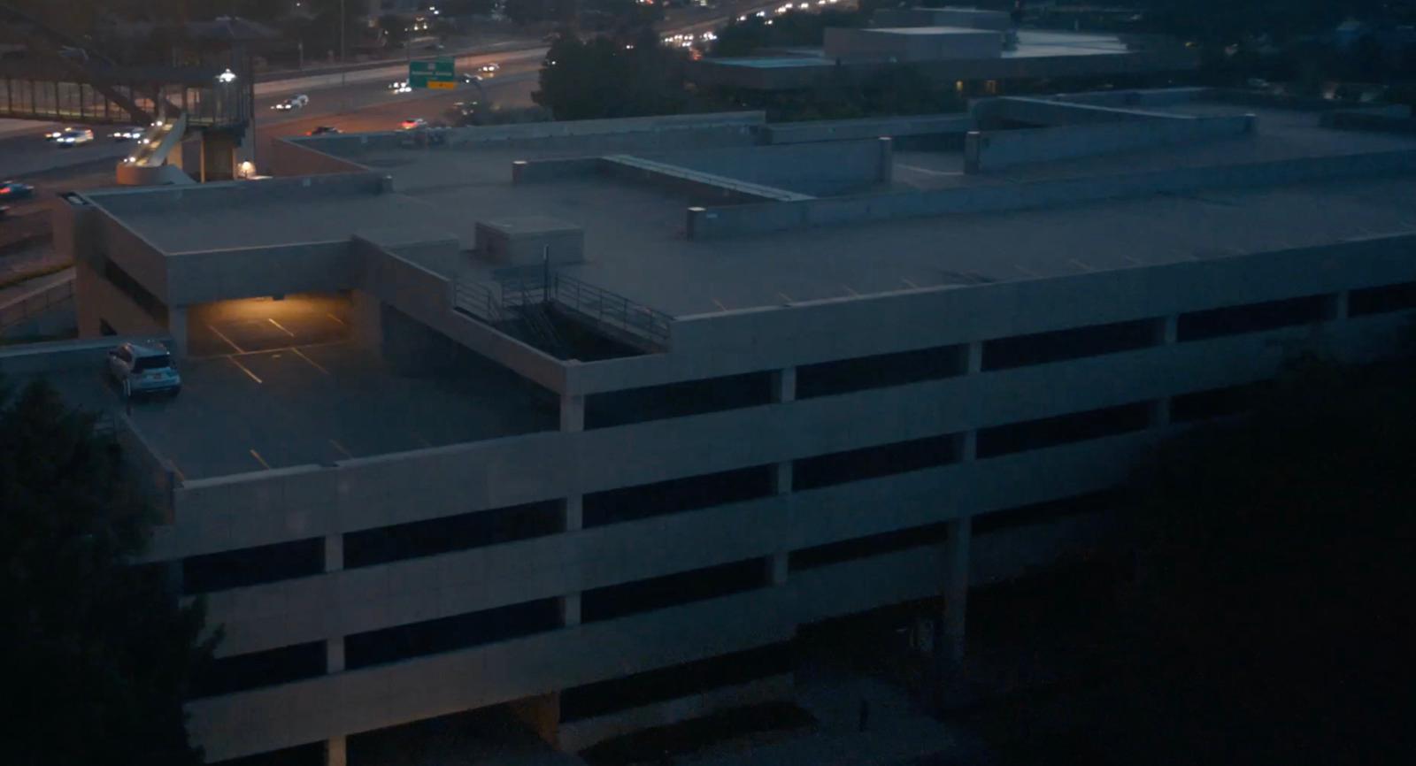 an aerial view of a parking garage at night