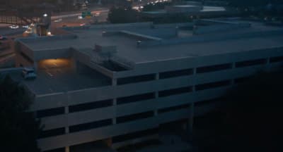 an aerial view of a parking garage at night