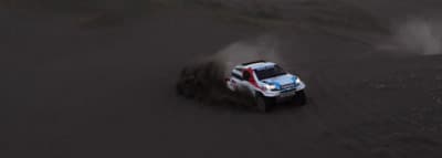 a white truck driving down a dirt road
