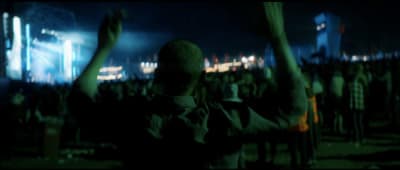 a man standing in front of a crowd at a concert
