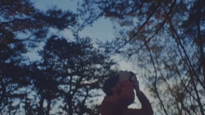 a man taking a picture of trees with his cell phone