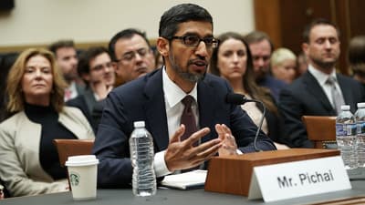 a man sitting at a table with a microphone in front of him