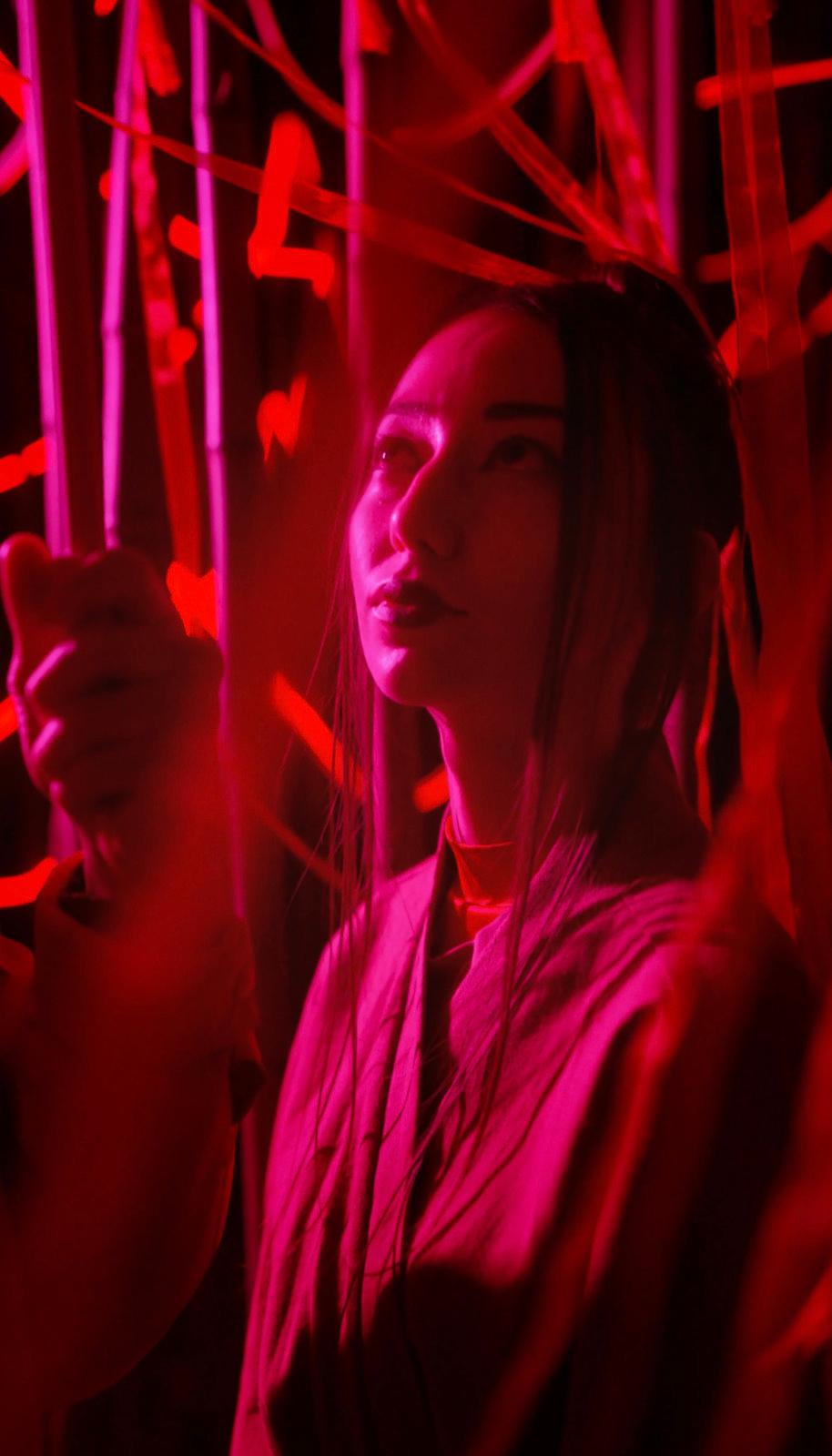 a woman holding a pair of scissors in her hand