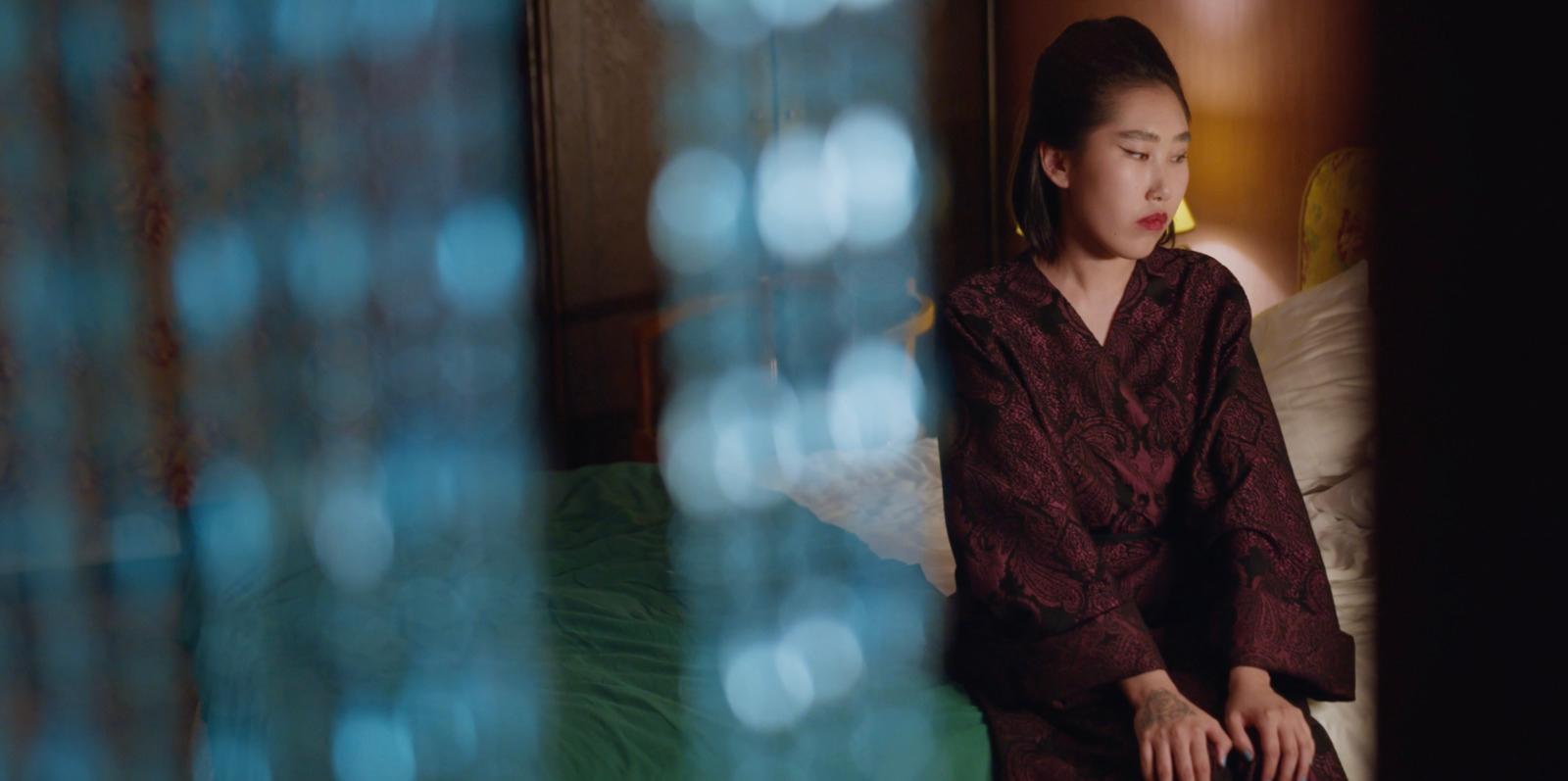 a woman sitting on a bed in a room