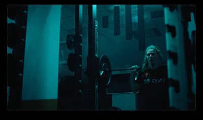 a woman standing in front of a gym machine