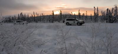 a couple of trucks that are in the snow