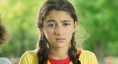 a young girl with a serious look on her face
