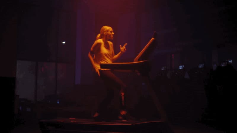 a woman standing on a chair in the dark