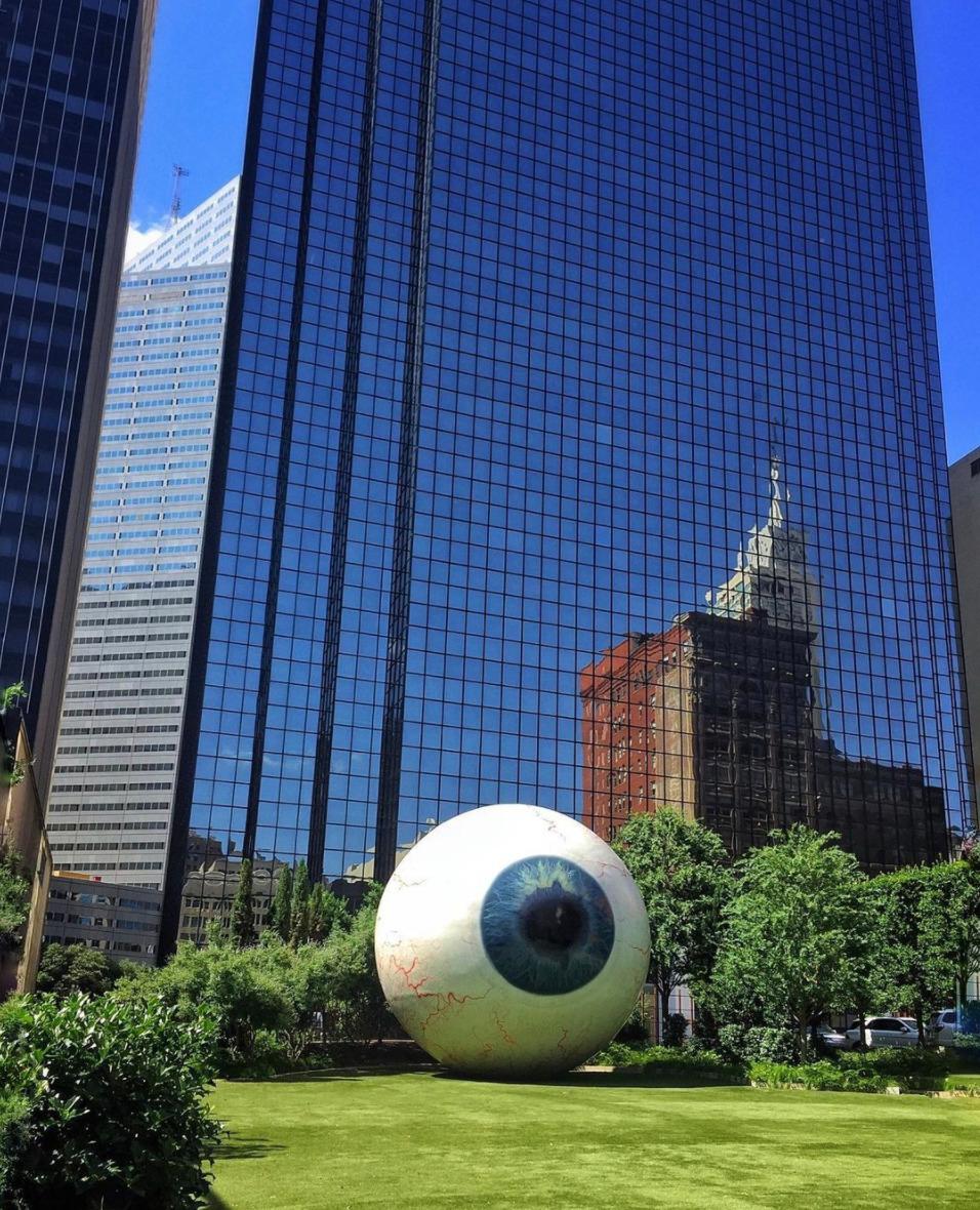 a large white ball sitting in the middle of a park