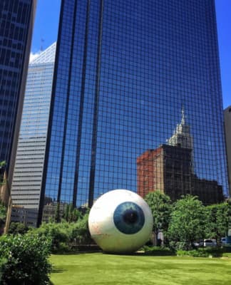 a large white ball sitting in the middle of a park