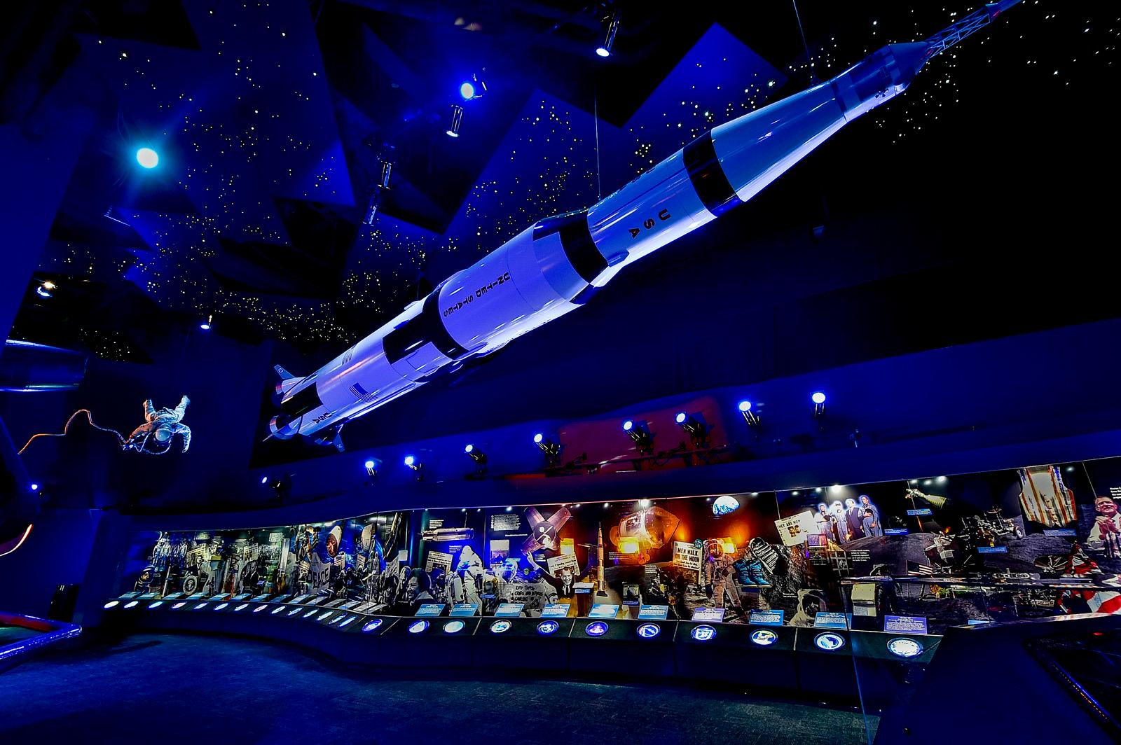 a space shuttle is suspended from the ceiling of a museum