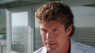 a close up of a person wearing a white shirt