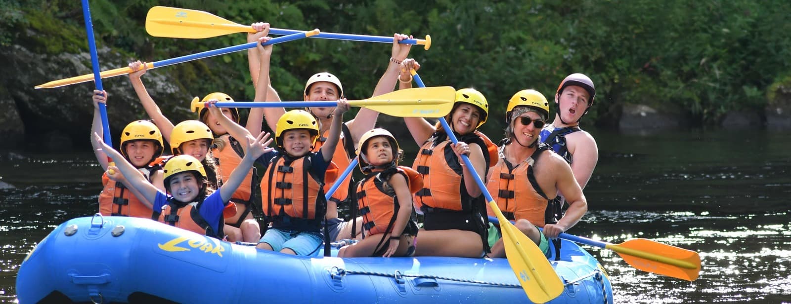 a group of people riding on the back of a raft