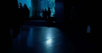 a group of people standing in a dark room
