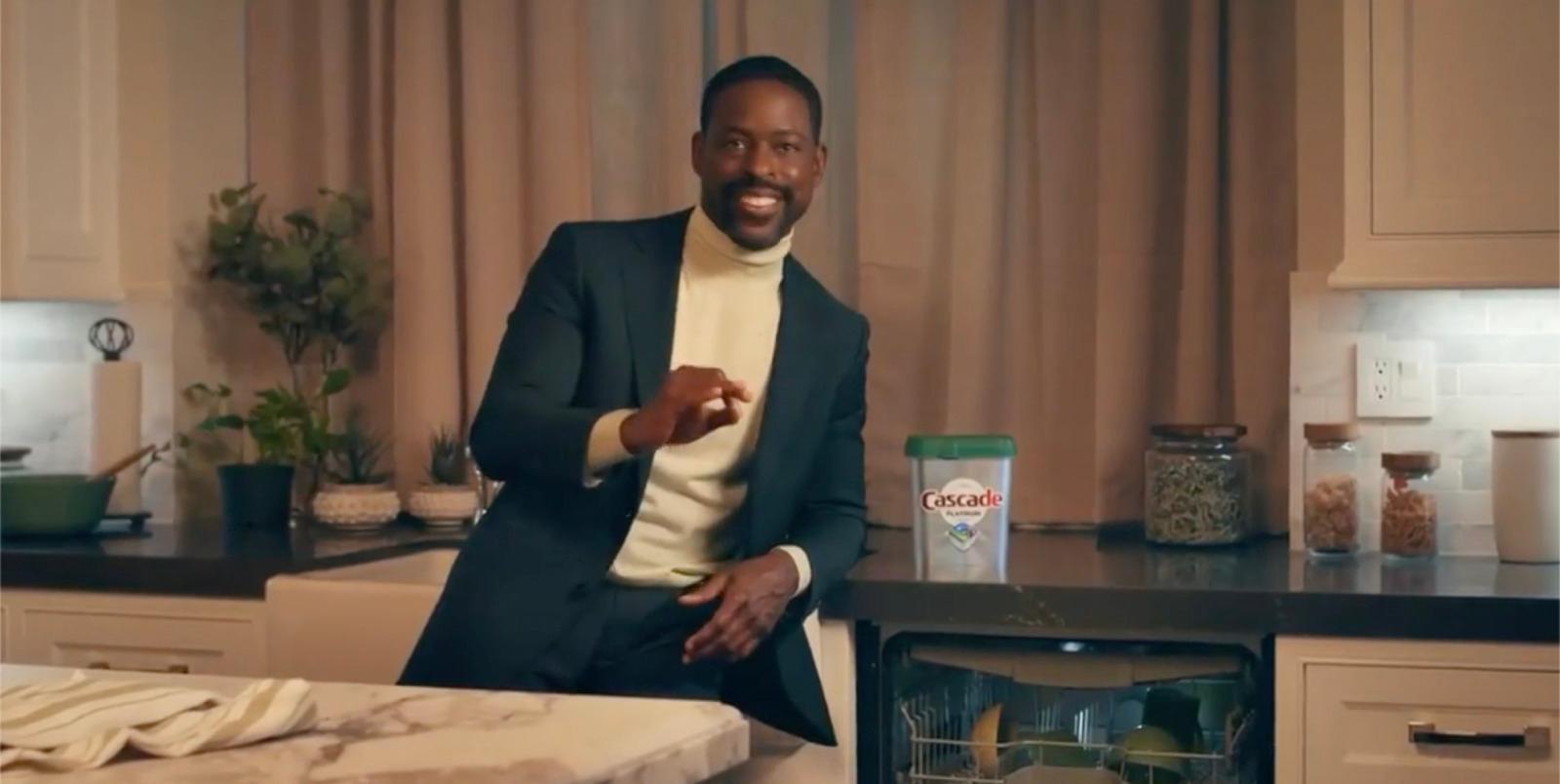 a man in a suit standing in a kitchen
