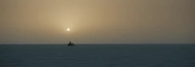 a lone boat in the middle of a large body of water