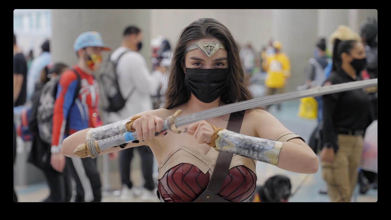 a woman in a cosplay outfit holding two swords