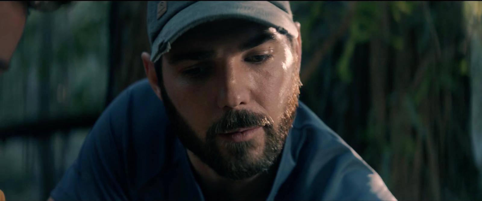 a man with a beard wearing a hat