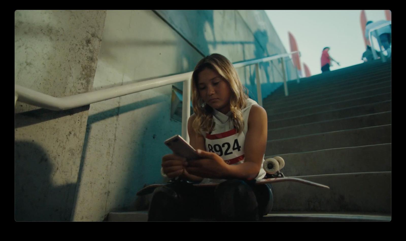 a young girl sitting on the steps using a cell phone