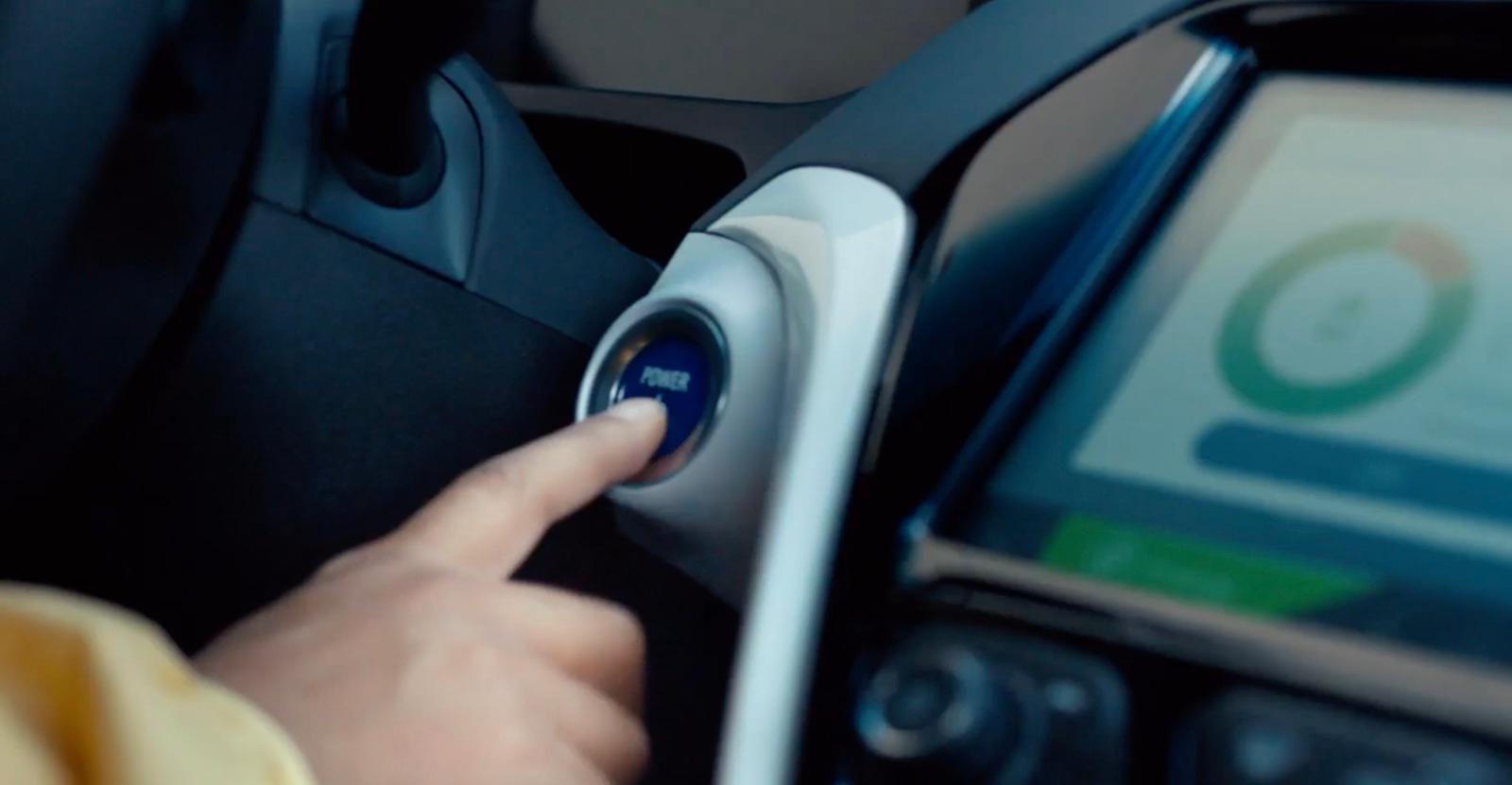 a person using a cell phone in a car