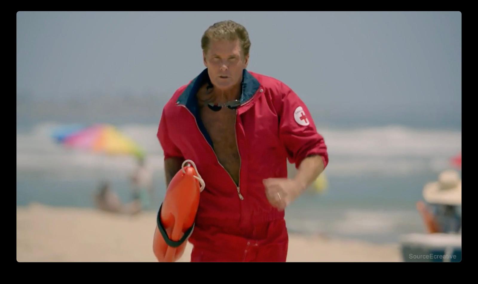 a man in a red swimsuit holding a life preserver
