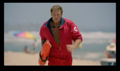 a man in a red swimsuit holding a life preserver