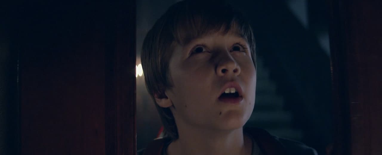a young boy with a surprised look on his face