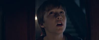 a young boy with a surprised look on his face
