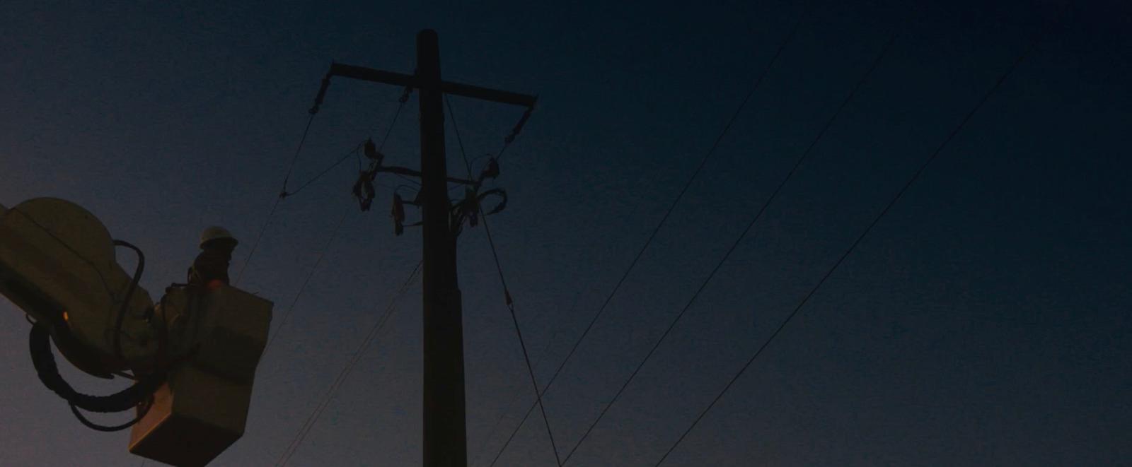 a street light and a telephone pole at night