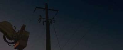 a street light and a telephone pole at night