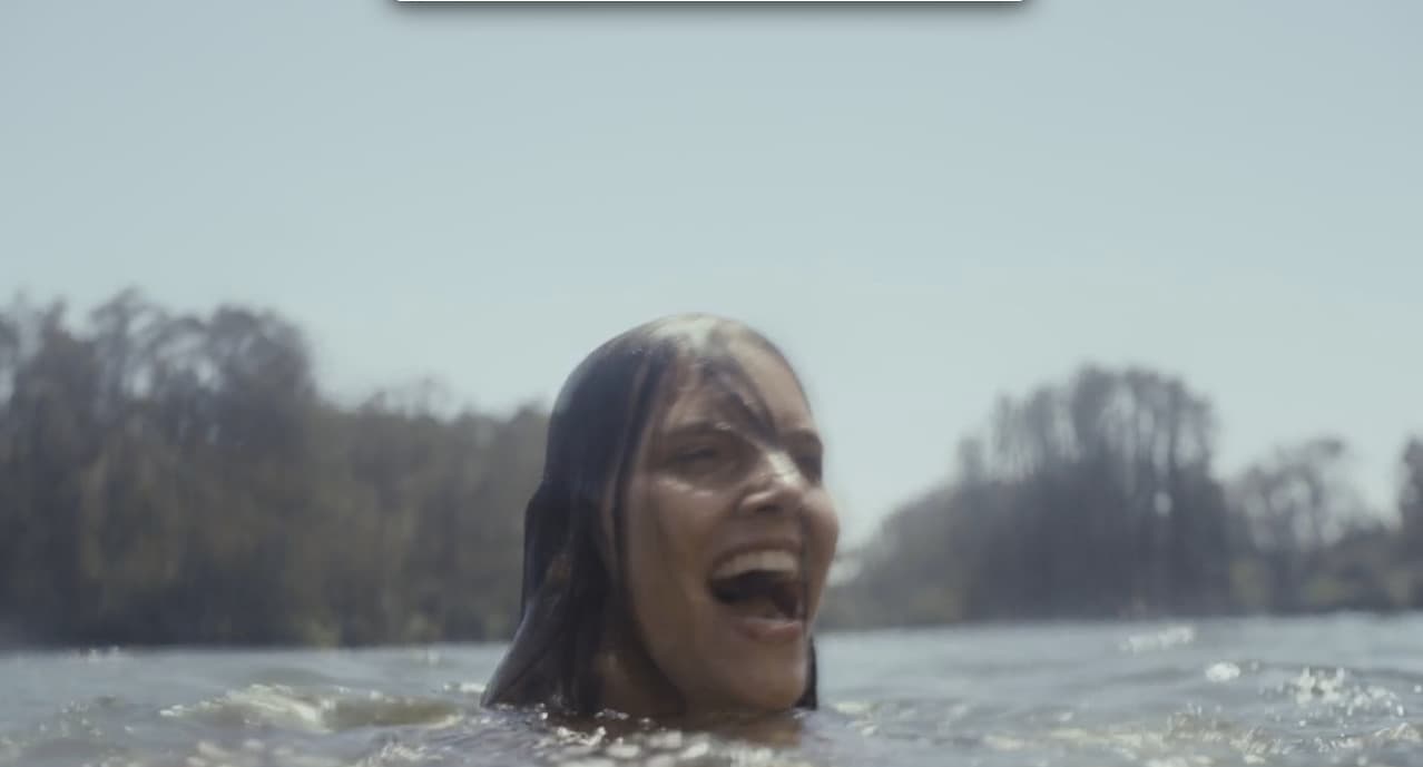 a woman in the water with her mouth open