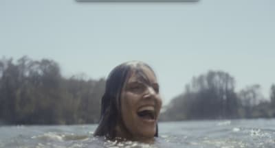 a woman in the water with her mouth open