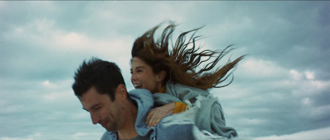 a man carrying a woman on his back